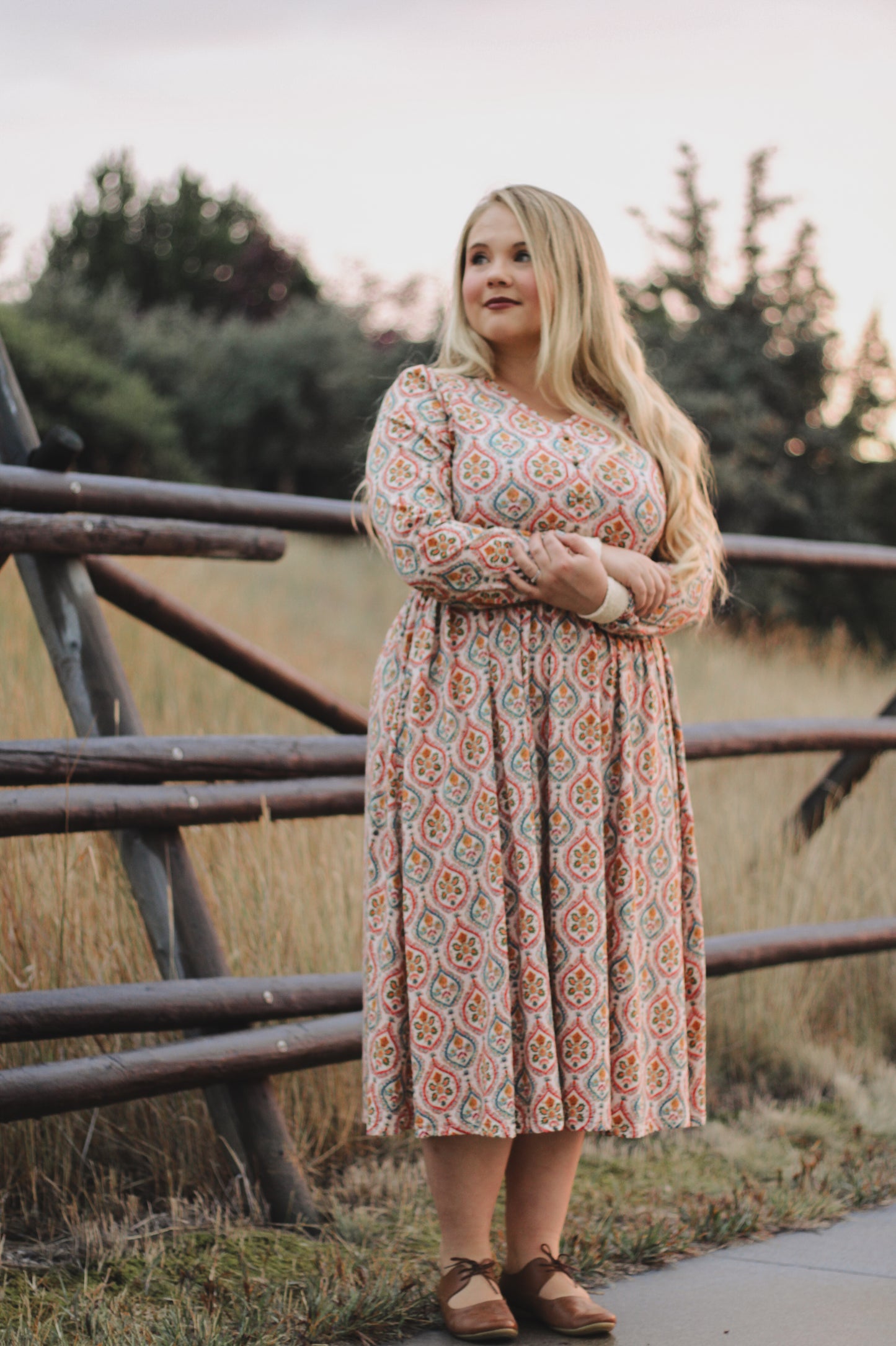 Woman wearing a patterned modest nursing dress