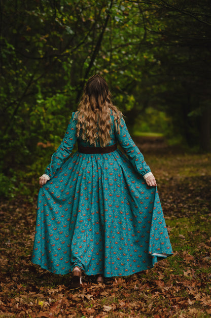 Woman in modest nursing teal floral dress walking