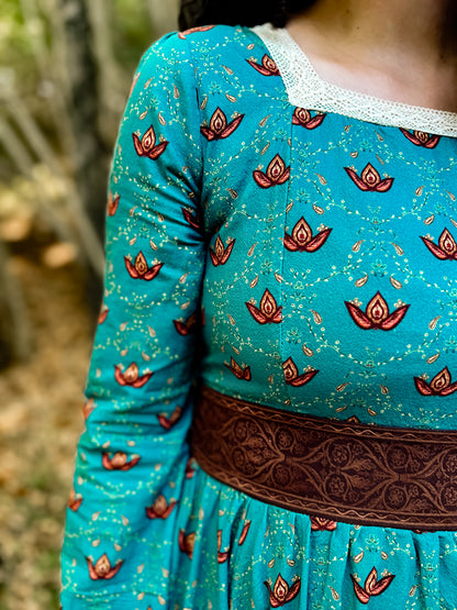 Woman in modest nursing teal dress with belt