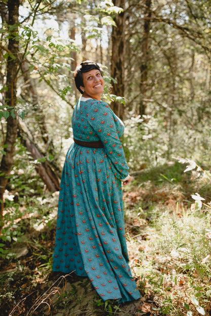 Woman in modest nursing teal patterned dress outdoors