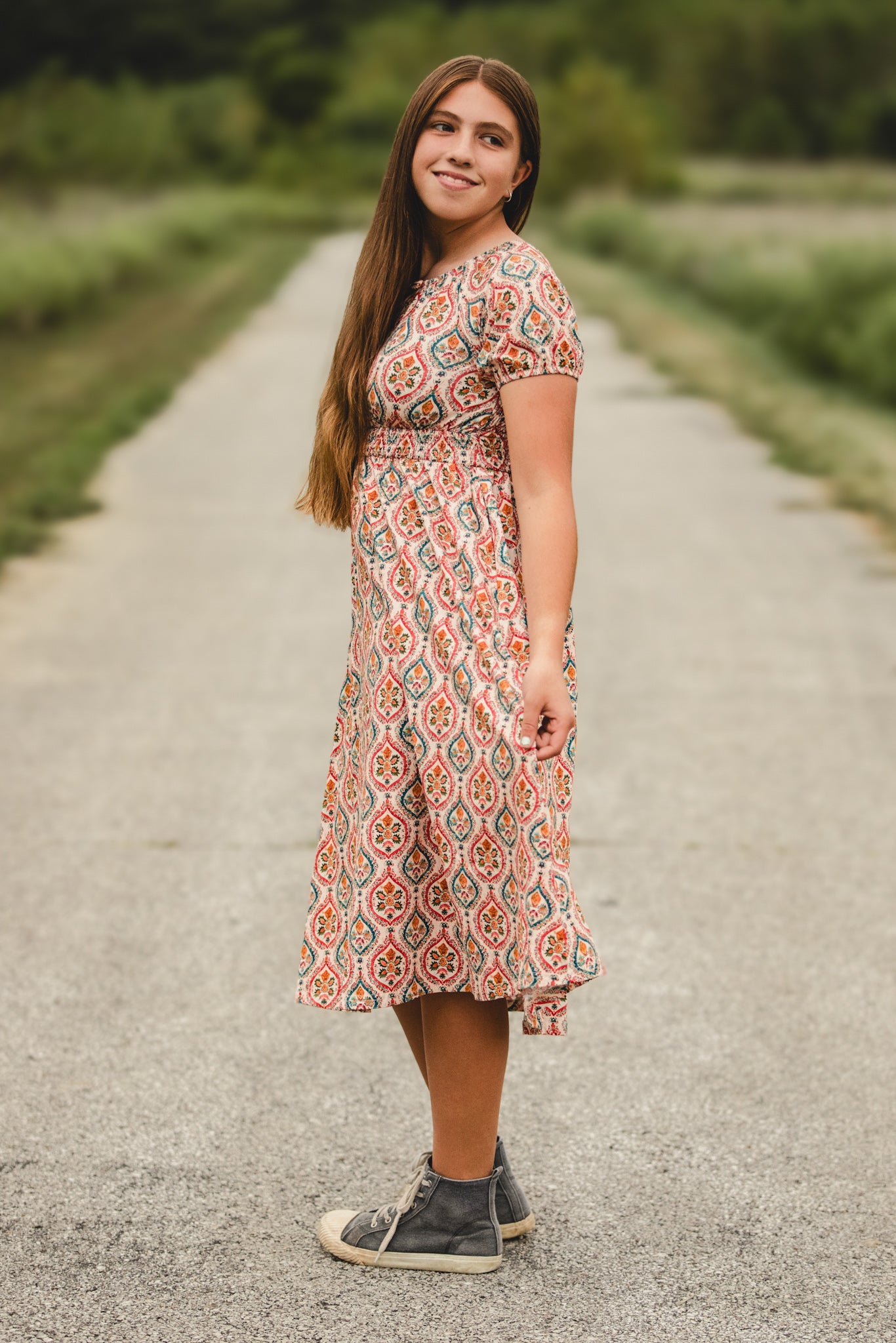 Woman in modest nursing dress on path