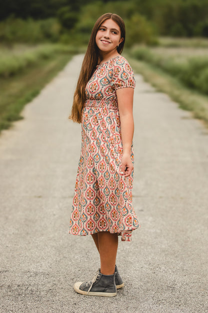 Woman in modest nursing dress on path