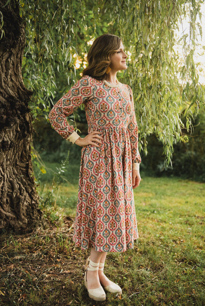 Woman wearing a patterned modest nursing dress