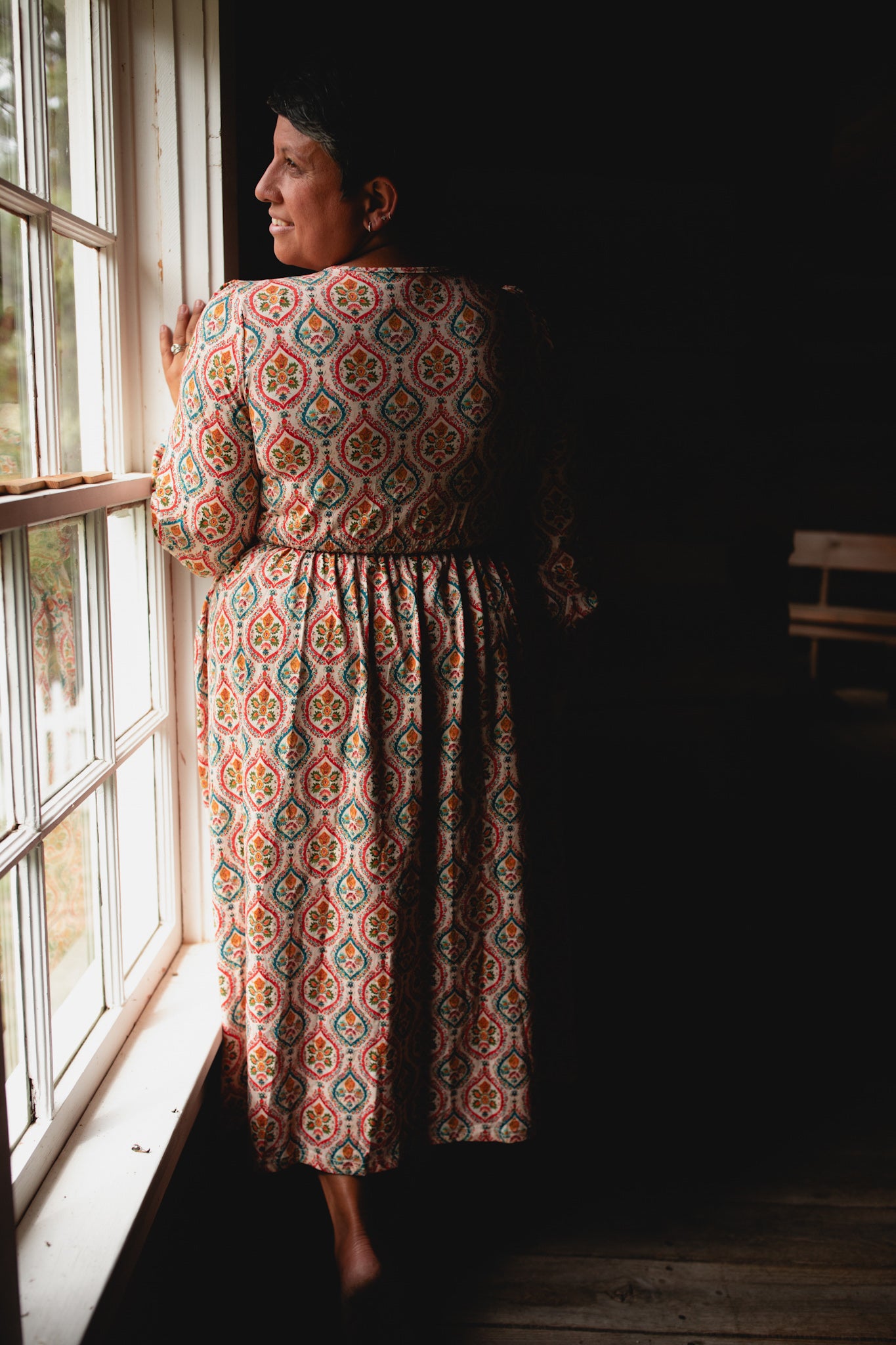 Woman wearing a patterned modest nursing dress