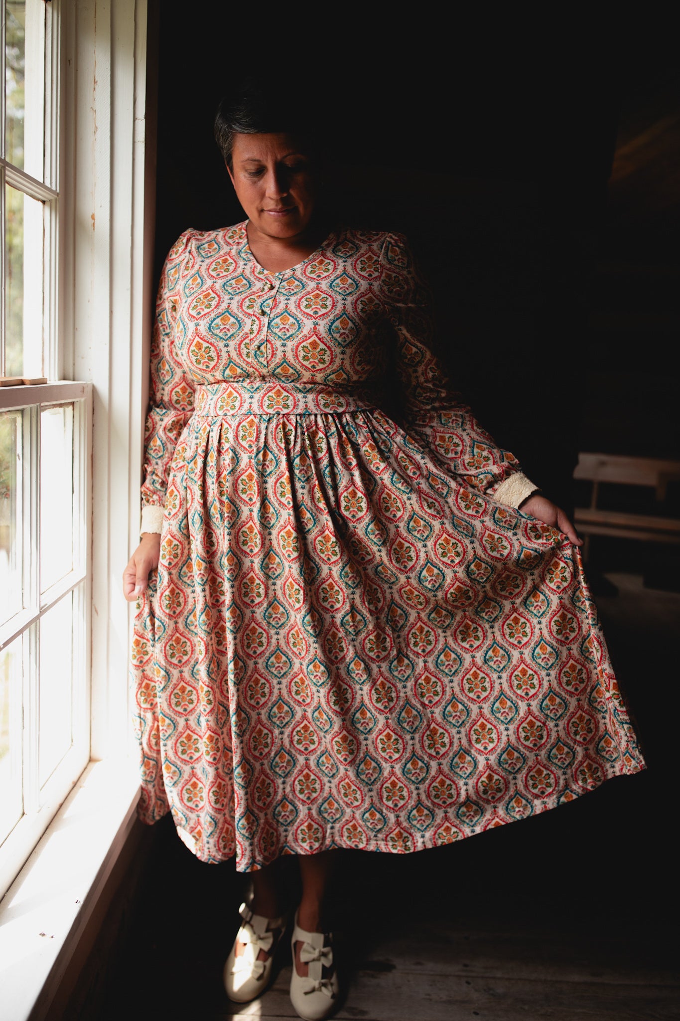 Woman wearing a patterned modest nursing dress