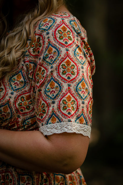 Woman wearing a patterned modest nursing dress