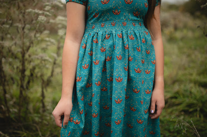 Woman wearing modest nursing dress with floral patterns
