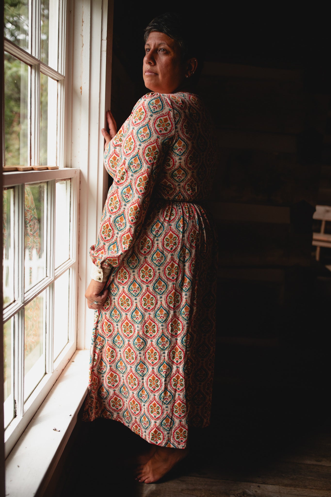 Woman wearing a patterned modest nursing dress