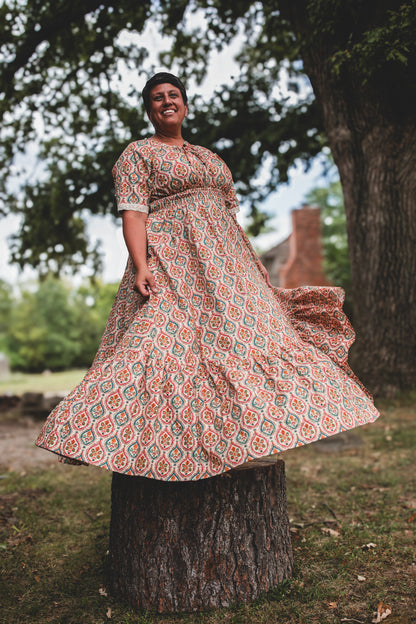 Woman wearing a patterned modest nursing dress