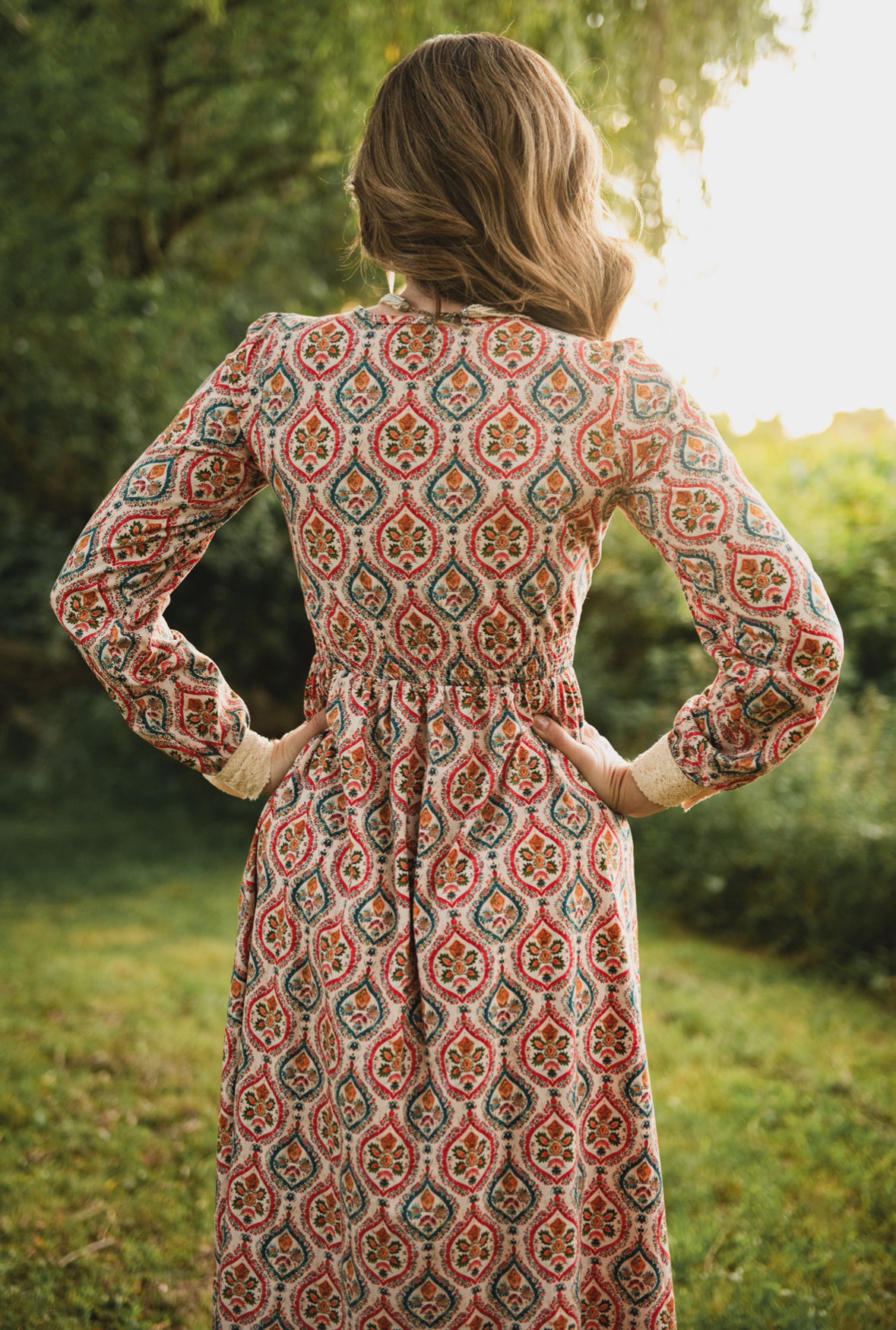 Woman wearing a patterned modest nursing dress