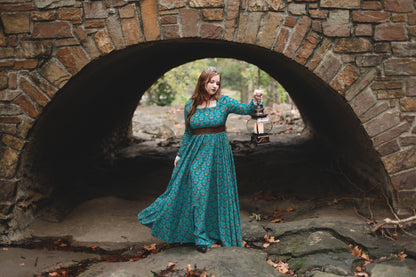 Woman in modest nursing teal dress in archway