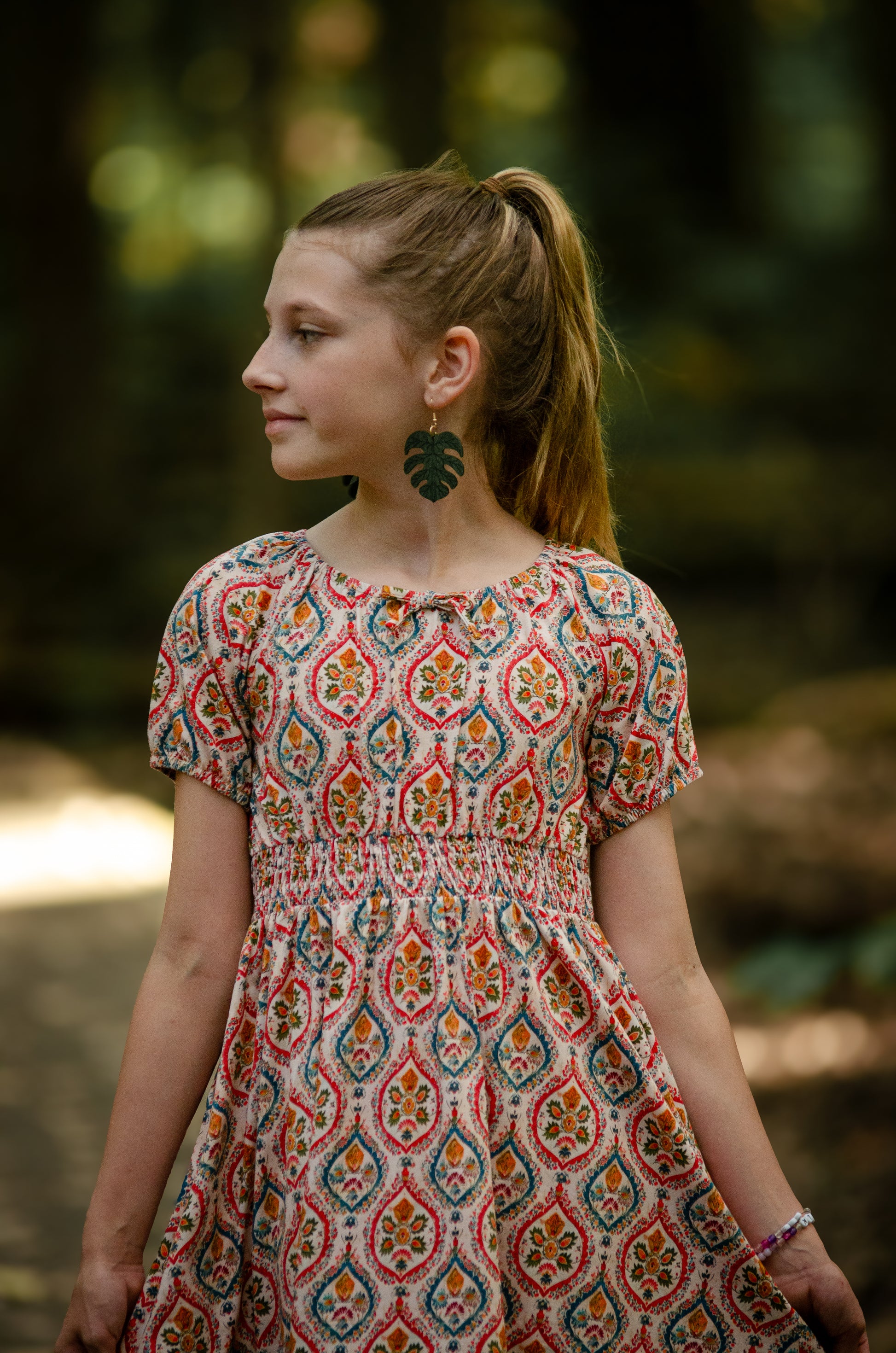 Girl in modest patterned dress outdoors