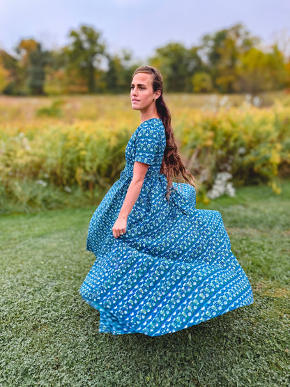 Woman in modest nursing dress in field