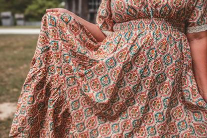Woman wearing a patterned modest nursing dress