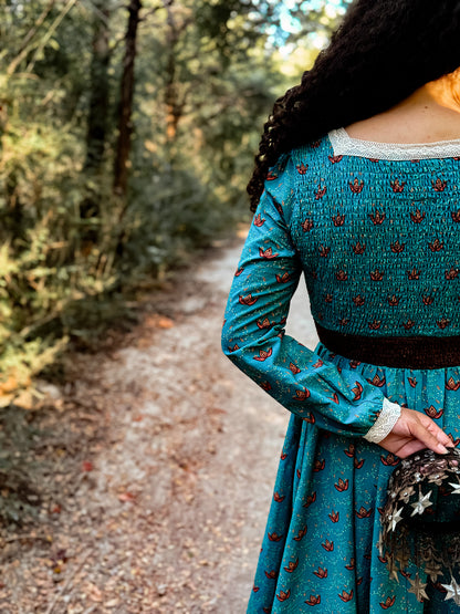 Woman in modest nursing teal patterned dress outdoors