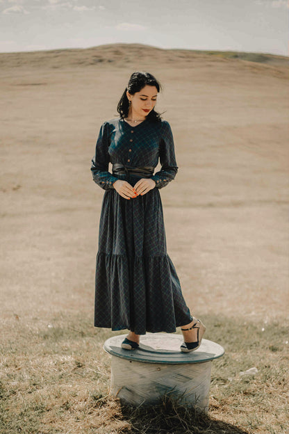 Woman in modest nursing dark green dress outdoors