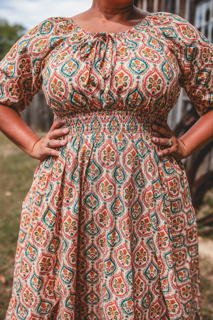 Woman wearing a patterned modest nursing dress