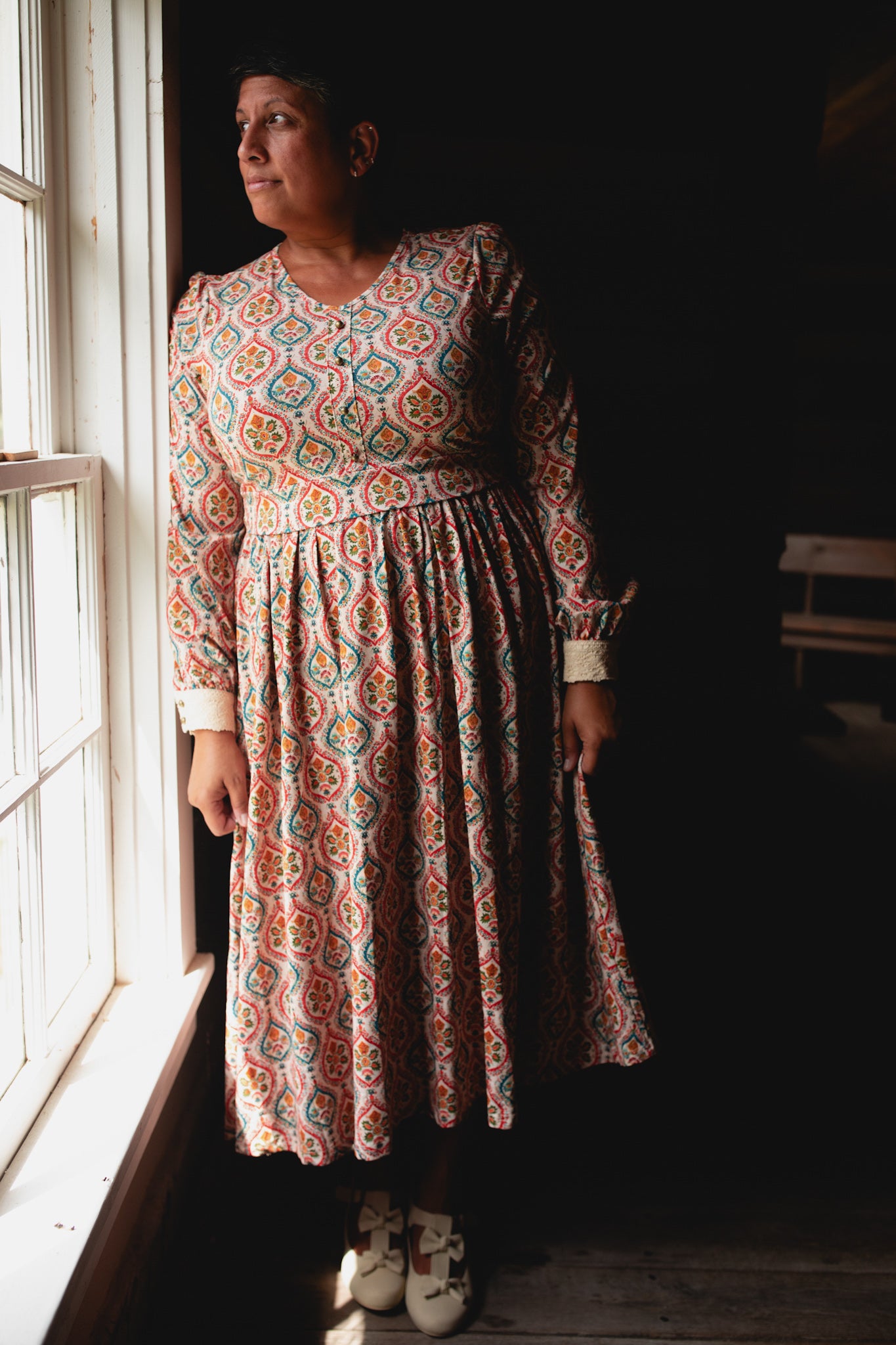 Woman wearing a patterned modest nursing dress