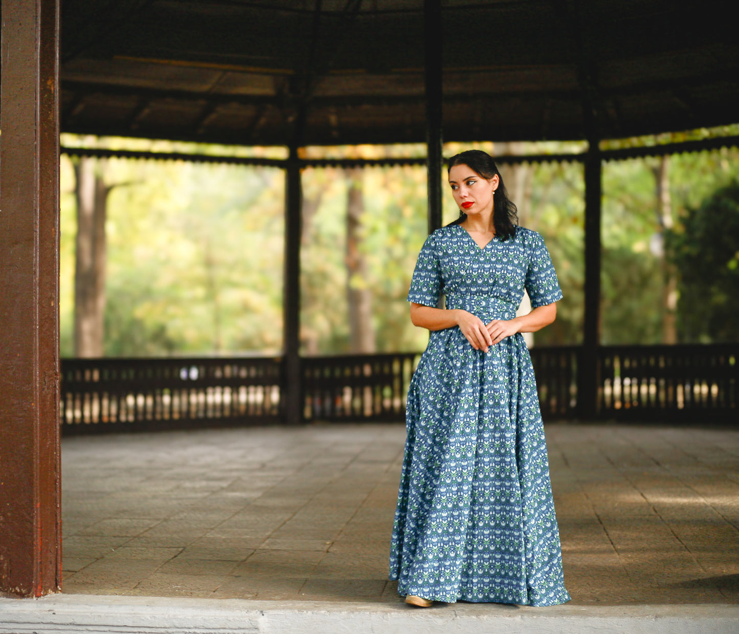 Woman in modest nursing dress in gazebo