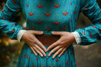 Woman in modest nursing blue dress with wallet
