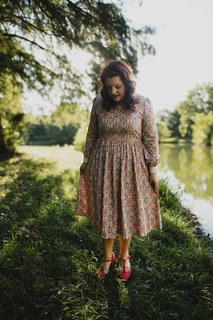 Woman wearing a patterned modest nursing dress