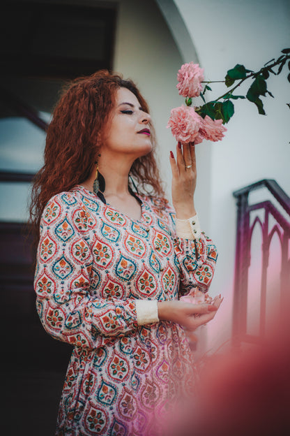 Woman wearing a patterned modest nursing dress