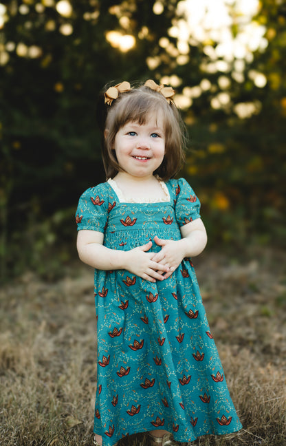 Young girl wearing modest dress with butterflies outdoors