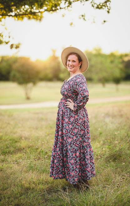 Woman in modest nursing floral dress outdoors.