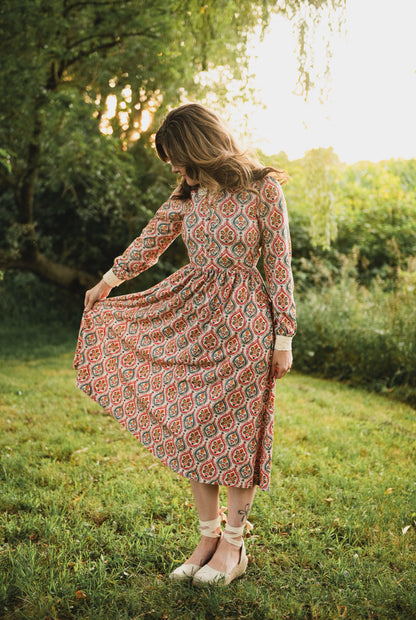 Woman wearing a patterned modest nursing dress