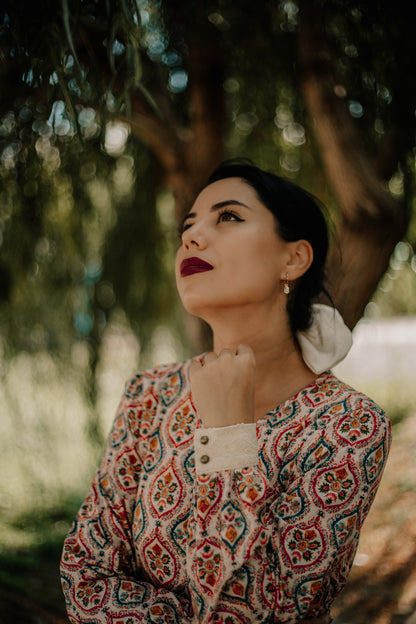 Woman wearing a patterned modest nursing dress