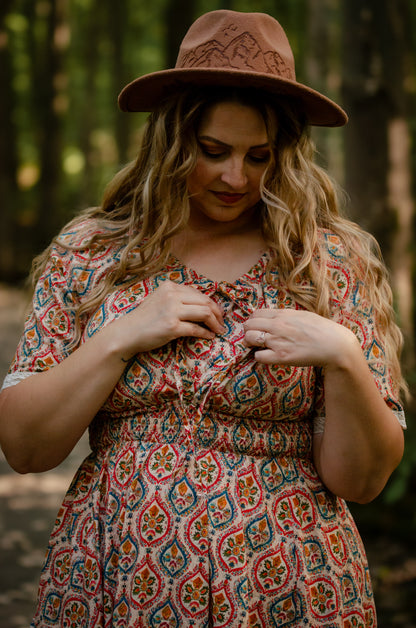 Woman wearing a patterned modest nursing dress