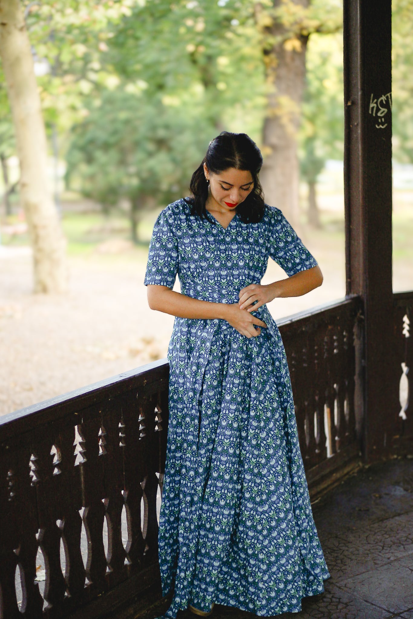 Woman in modest nursing dress on porch