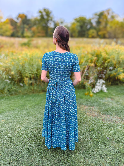 Woman in modest nursing dress in field