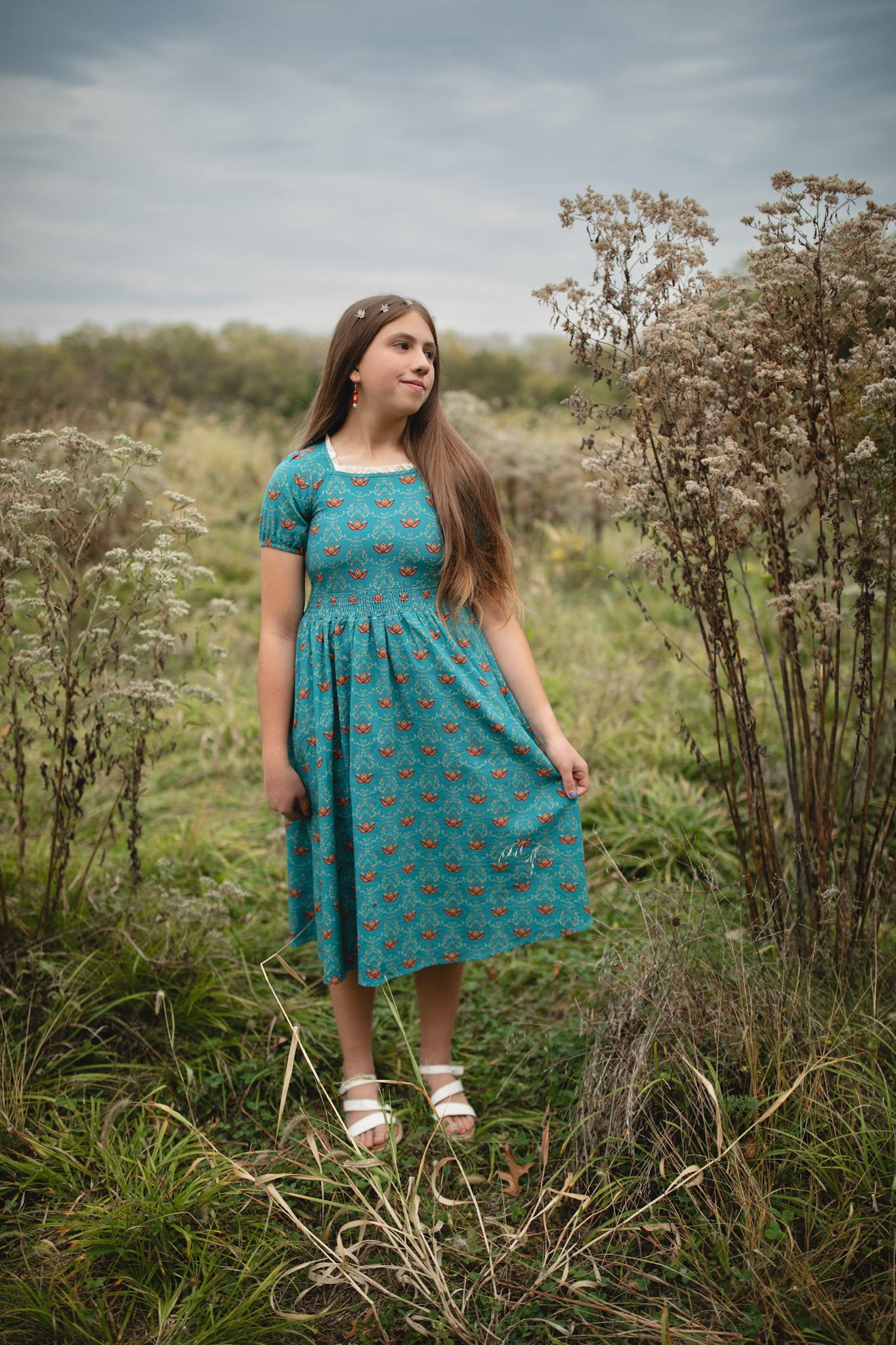 Woman wearing modest nursing dress in field outdoors