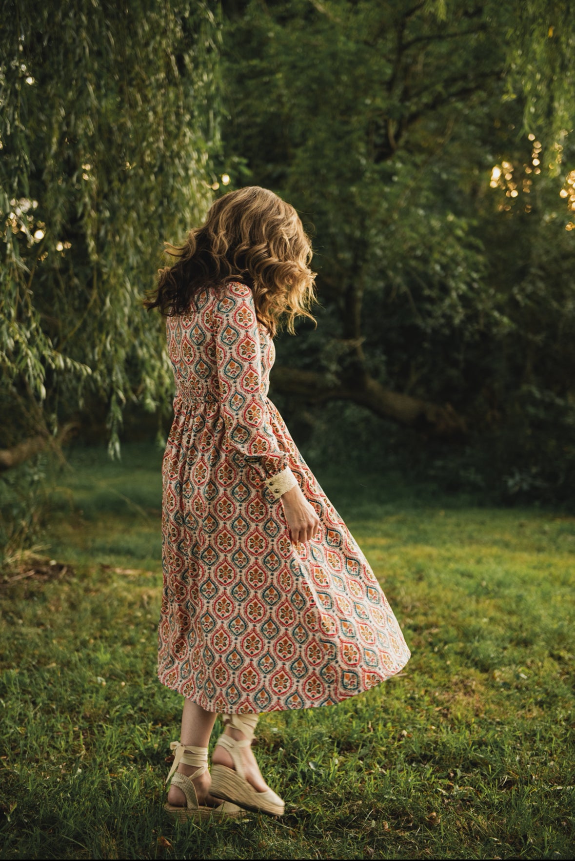 Woman wearing a patterned modest nursing dress