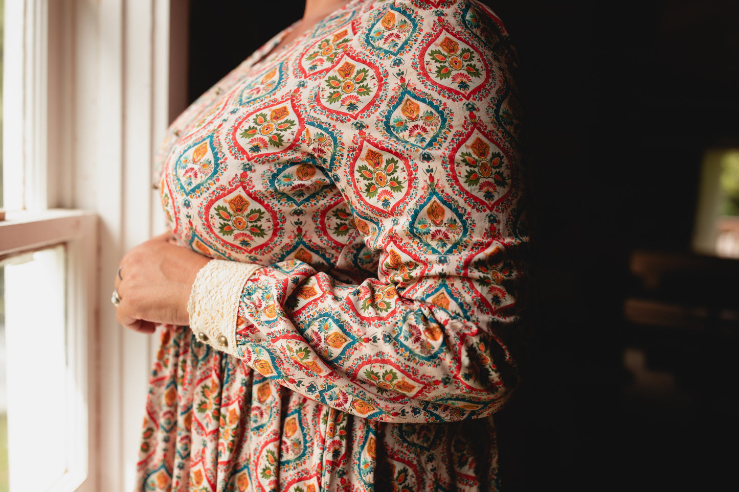 Woman wearing a patterned modest nursing dress