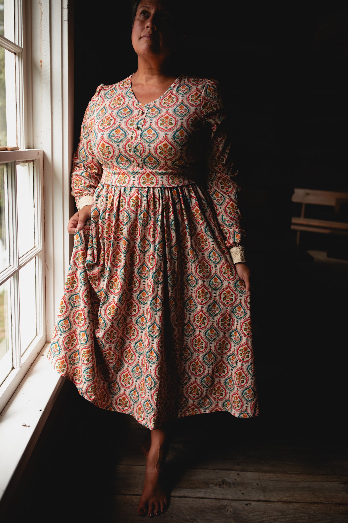Woman wearing a patterned modest nursing dress