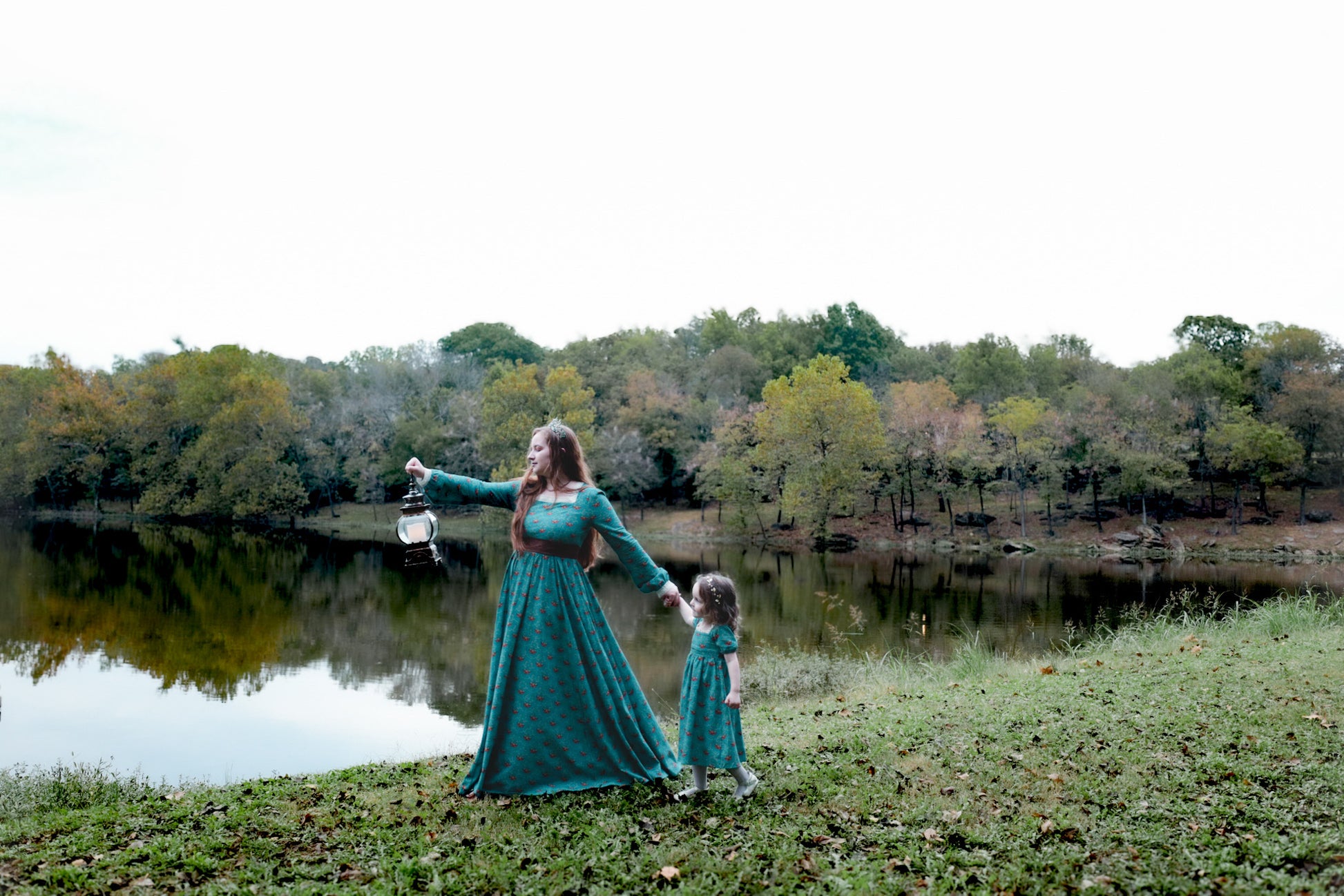 Woman wearing modest nursing dress with child by lake.