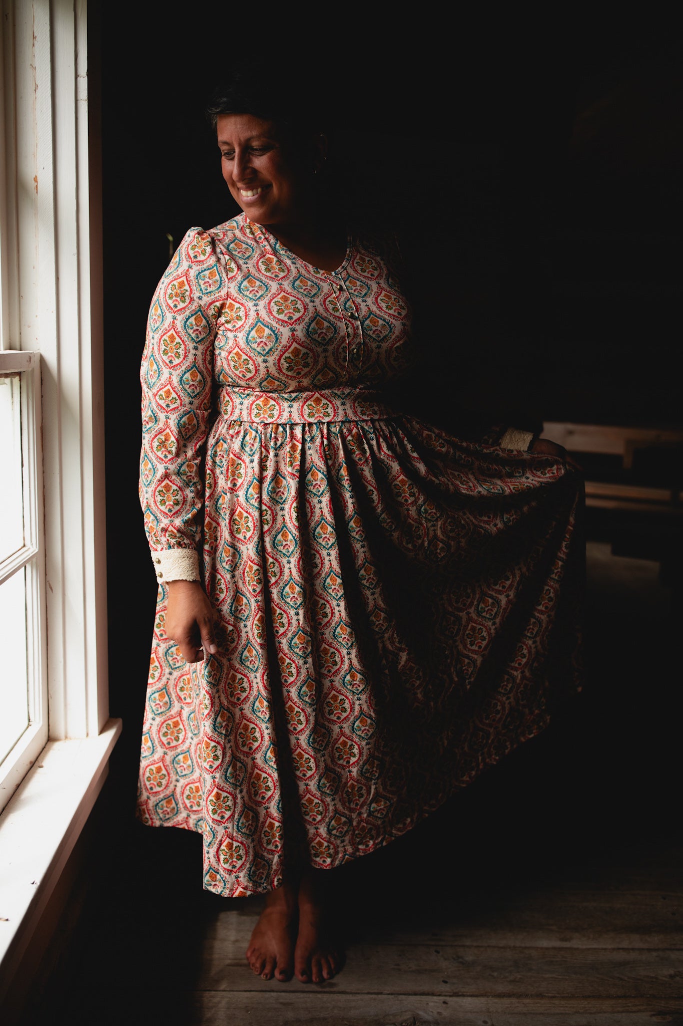 Woman wearing a patterned modest nursing dress