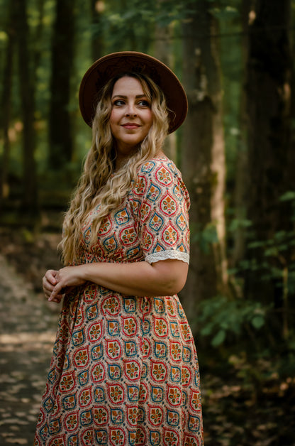 Woman wearing a patterned modest nursing dress
