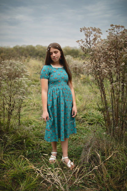 Woman wearing modest nursing dress in field outdoors