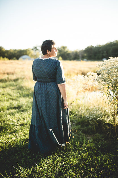 woman wearing a modest nursing blue patterned dress