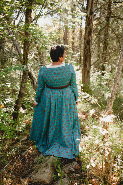 Woman in modest nursing teal patterned dress outdoors