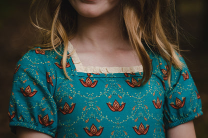 Close-up of modest nursing dress with floral patterns.