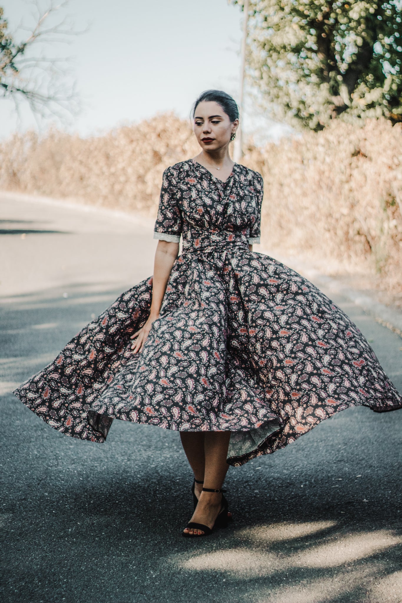 Woman in modest nursing dress with floral pattern outdoors