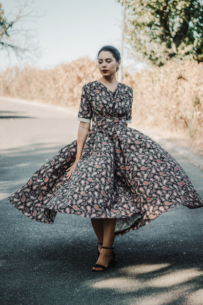 Woman in modest nursing dress with floral pattern outdoors