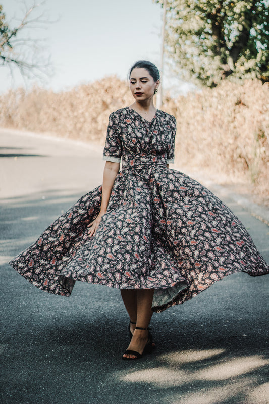Woman in modest nursing dress with floral pattern outdoors
