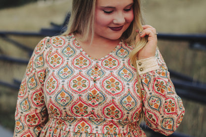 Woman wearing a patterned modest nursing dress