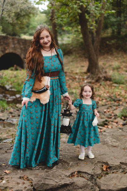 Two women in modest nursing teal dresses outdoors