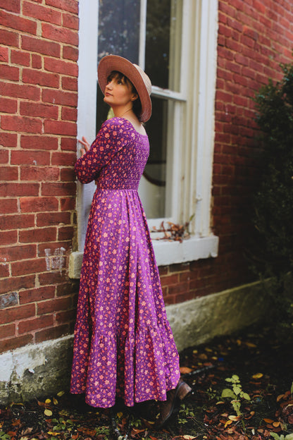 Woman in modest purple nursing dress outdoors